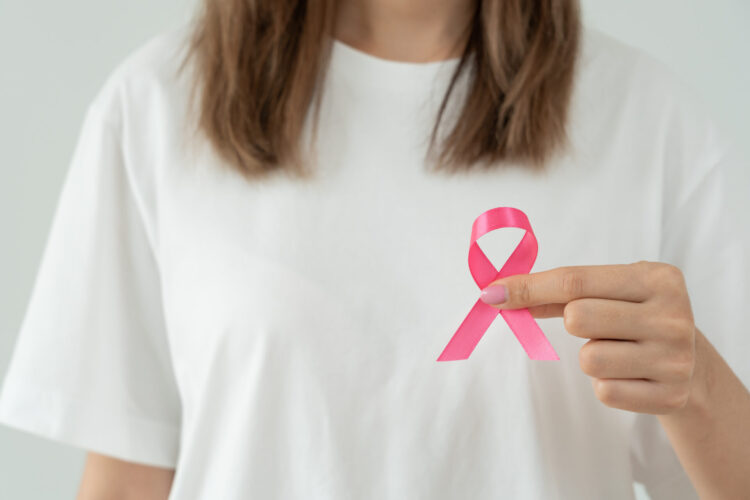 Woman hold pink ribbon breast cancer awareness. Female health check consciousness. international Women Day and World Cancer Day. sign cancer, Symbolic, health care, support patients, timely diagnosis